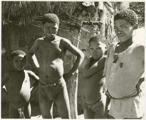 Boys standing beside the Okwa hut with wall drawings (print is a cropped image)