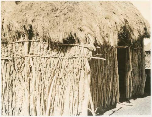 Exterior of the Okwa hut with wall drawings (print is a cropped image)