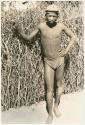 Boy standing outside (print is a cropped image)