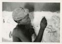 Boy drawing on the wall in Okwa