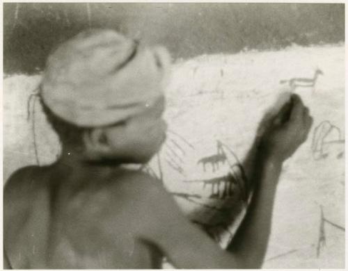 Boy drawing on the wall in Okwa (print is a cropped image)