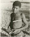 Boy playing musical instrument (print is a cropped image)