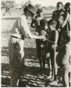 Children receiving food from Lorna Marshall at Okwa (print is a cropped image)