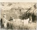 Boys and his family standing in the kraal (clearing) of his home (print is a cropped image)