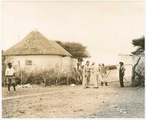 Laurence Marshall, John Marshall, and L. F. Maingard at gate of administration compound at Tsani (print is a cropped image)