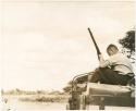 Theunis Berger on top of the truck holding a gun (print is a cropped image)