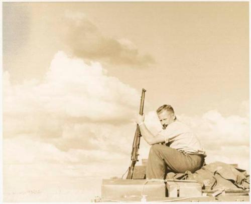 Theunis Berger on top of the truck holding a gun (print is a cropped image)