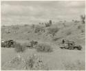 Four trucks in a riverbed out from Molepolole (print is a cropped image)