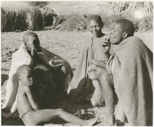 Group of five people, one smoking a cigarette (print is a cropped image)