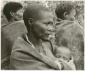 Three woman, one holding a baby in her blanket (print is a cropped image)