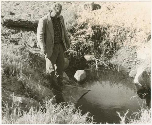 Theunis Berger standing by a dug waterhole at Kungwane (print is a cropped image)