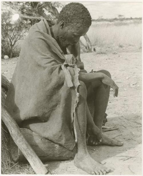 Headman at Kungwane sitting looking at the ground (print is a cropped image)