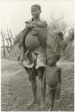 Three seated children beside a cooking pot at Chukudu (print is a cropped image)