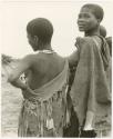 Two women standing, backs facing (print is a cropped image)