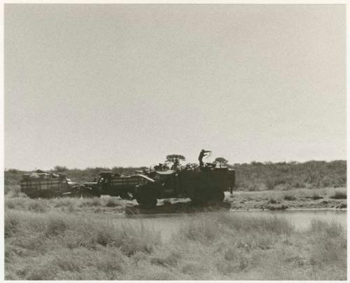 Expedition members and trucks at !Kusi Pan, from a distance (print is a cropped image)