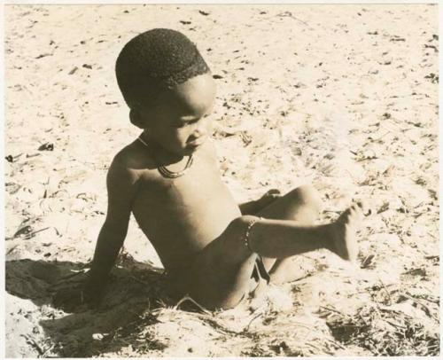 Child sitting with one leg up (print is a cropped image)