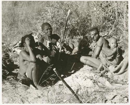 /Twikwe, Tsekue, N!whakwe, and two others watching the gemsbok butchering (print is a cropped image)