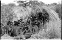 Group of Ju/'hoansi telling stories including left to right: "Lame ≠Gao" seen from behind, ≠Gao (Khwo//o-/Gasa's husband), "Gao Medicine," unidentified person seen from behind, ≠Toma, !Naishi, "Old Xama" with her hands over her head, "Gao Helmet" in profile, "Old Demi" lying down, "Crooked /Qui," Gao (Debe's son, Zuma's husband), ≠Toma (!Naishi's son), and Zuma (Gao's wife)