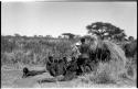 Group of Ju/'hoansi telling stories including "Lame ≠Gao," ≠Gao (Khwo//o-/Gasa's husband), "Gao Medicine," an unidentified person, ≠Toma, !Naishi, "Old Xama," "Gao Helmet," "Old Demi" lying down, Crooked /Qui, Gao (Debe's son, Zuma's husband), and ≠Toma (!Naishi's son)