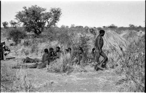 Group of Ju/'hoansi telling stories including "Lame ≠Gao," ≠Gao (Khwo//o-/Gasa's husband), "Gao Medicine," an unidentified person, ≠Toma, !Naishi, "Old Xama," "Gao Helmet," "Old Demi" lying down, Crooked /Qui, Gao (Debe's son, Zuma's husband), and ≠Toma (!Naishi's son)