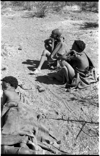 "Old /Gasa," an unidentified woman and child, and /Naoka ("Gao Medicine's" first wife) lying down