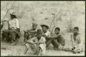 Group of seated men at Kubi including Isaac Otuhile (chief at Kubi appointed by Queen Moremi) sitting on a chair and his son