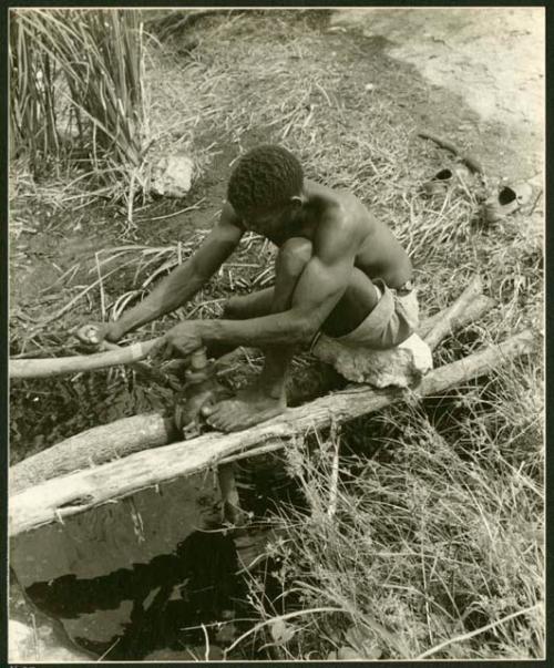 Man pumping water from a waterhole