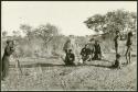 John Marshall and unidentified Ju/'hoan boys around an ant hill while Ngani films them