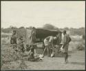 Expedition members and Ju/'hoansi around the sound equipment tent at the Gautscha expedition camp