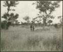 John Marshall and unidentified Ju/'hoansi standing among trees