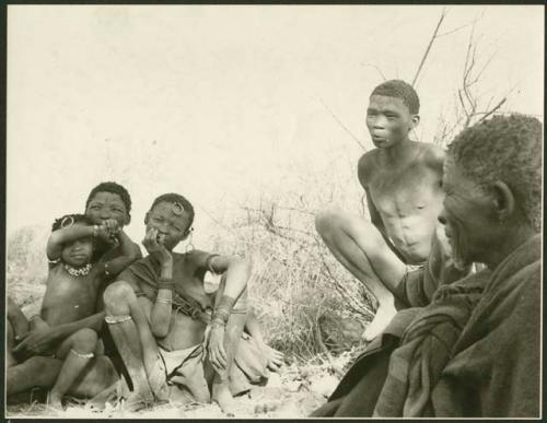 Men, woman, and children sitting