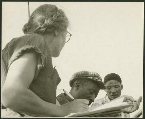 Lorna Marshall taking notes with Frederick Geib and /Gao sitting next to her