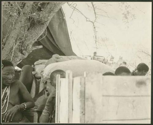 Ju/'hoansi on top of a loaded expedition truck