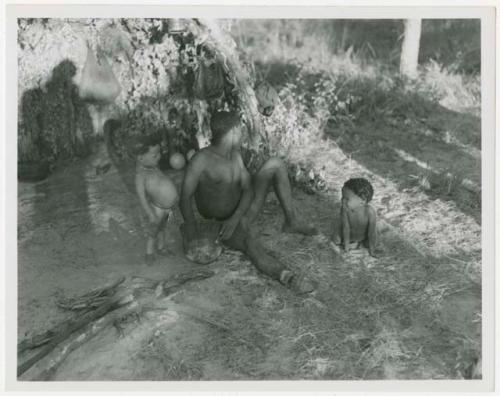 Man sitting with two children