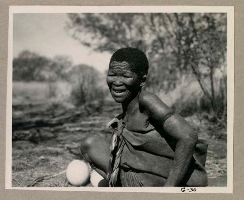 Woman seated, smiling

