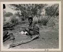 Woman seated with two ostrich egg shells