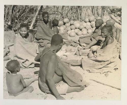 Group at Chukudu sitting beside pile of tsama melons
