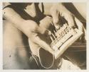 Man playing a musical instrument, close-up on hands
