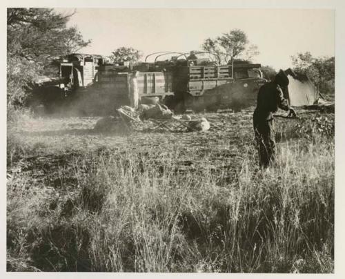 Two expedition members clearing the camp site
