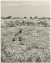 /Twikwe clearing ground with a digging stick, distant view (print is a cropped image)