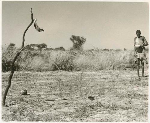 /Twikwe in a clearing holding a pan (print is a cropped image)