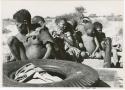 Oukwane, /Twikwe, Tsekue, and four others on top of expedition truck