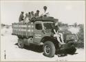 Oukwane, /Twikwe, /Gaiamakwe, Kernel Ledimo, Lorna Marshall, and another person on top of expedition truck, Elizabeth Marshall Thomas on fender