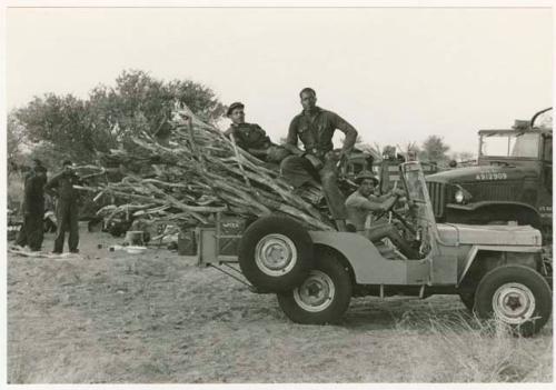 Casper Kruger, Simon Molamo, and another expedition member in a Jeep full of wood (print is a cropped image)