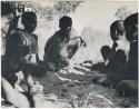 [No folder title]: Group of boys playing /Ui (the counting game) in the sand (print is a cropped image)