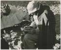 Robert Story sitting and reading a book (print is a cropped image)