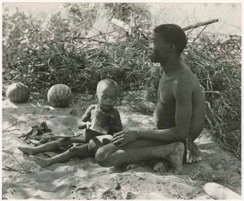 !Gai and Oukwane sitting at their living place in the werft (print is a cropped image)