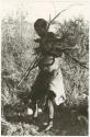 /Twikwe carrying wood (print is a cropped image)