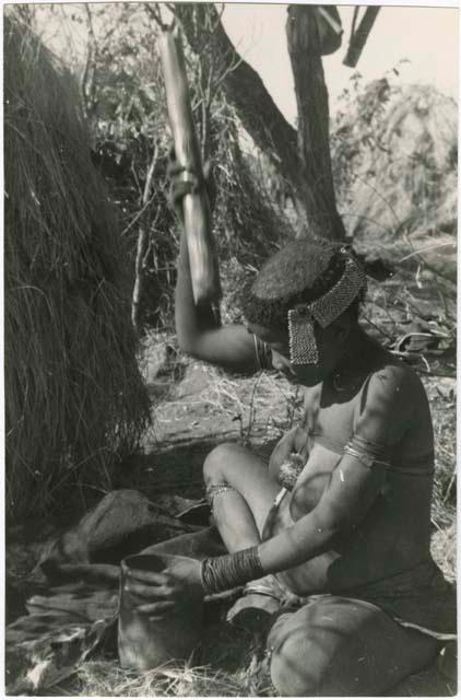 [No folder title]: //Kushay ("Gao Helmet's" second wife) pounding with mortar and pestle (print is a cropped image)