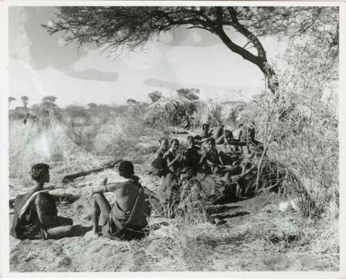 [No folder title]: "Gao Helmet" sitting with his extended family and relatives (print is a cropped image)